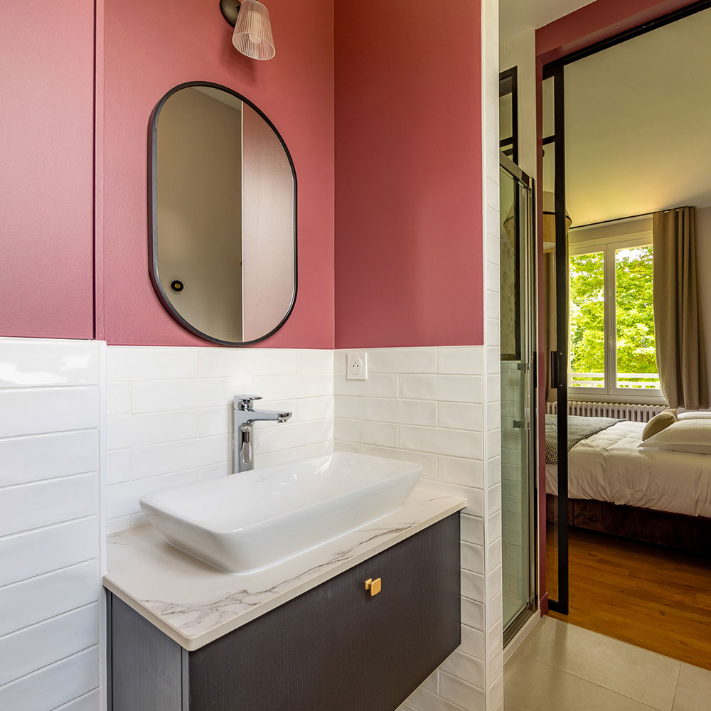 Salle de bain avec douche et toilettes dans la suite rose